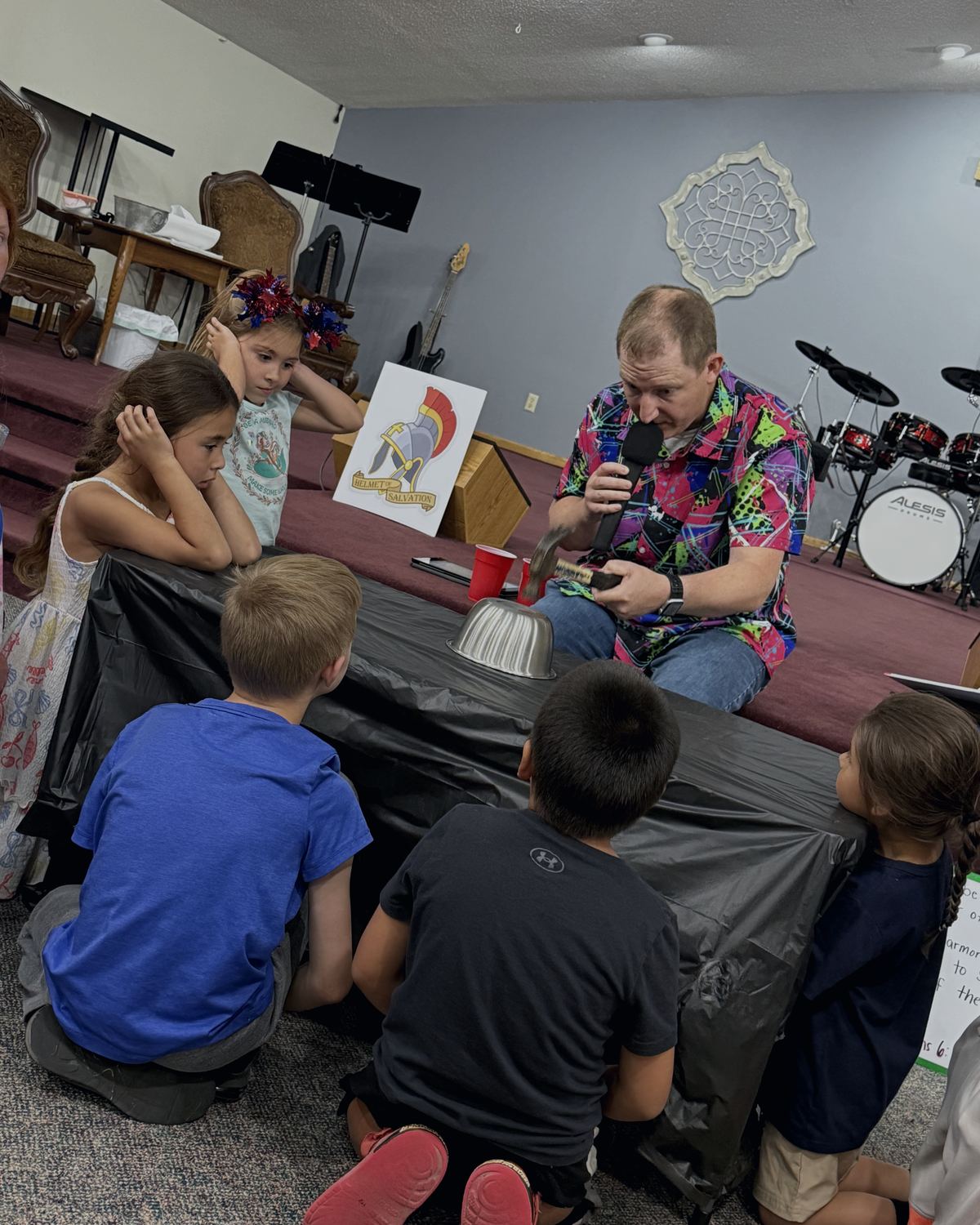 A Calvary UPC leader teaching a group of children